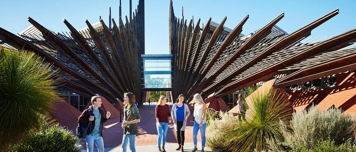 Students walking between the timber fins of the Edith Cowan University campus building