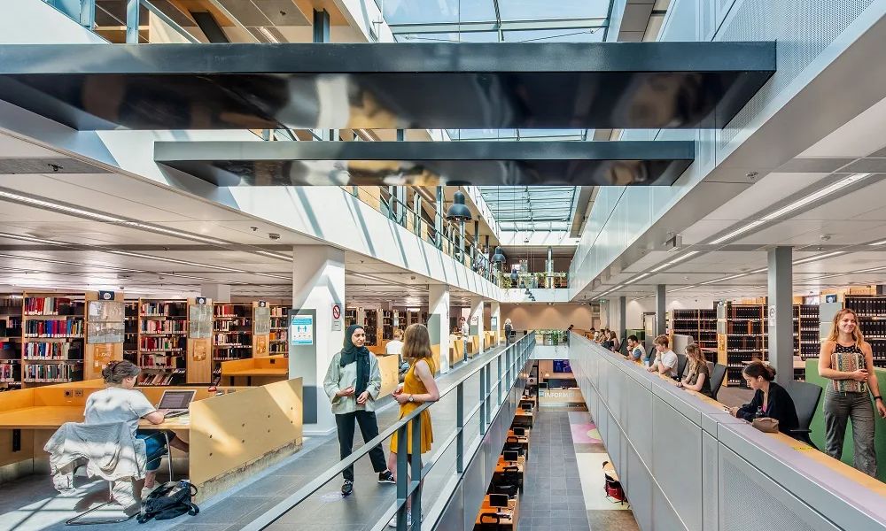 Students studying on the galleried floors of the Maastricht University library